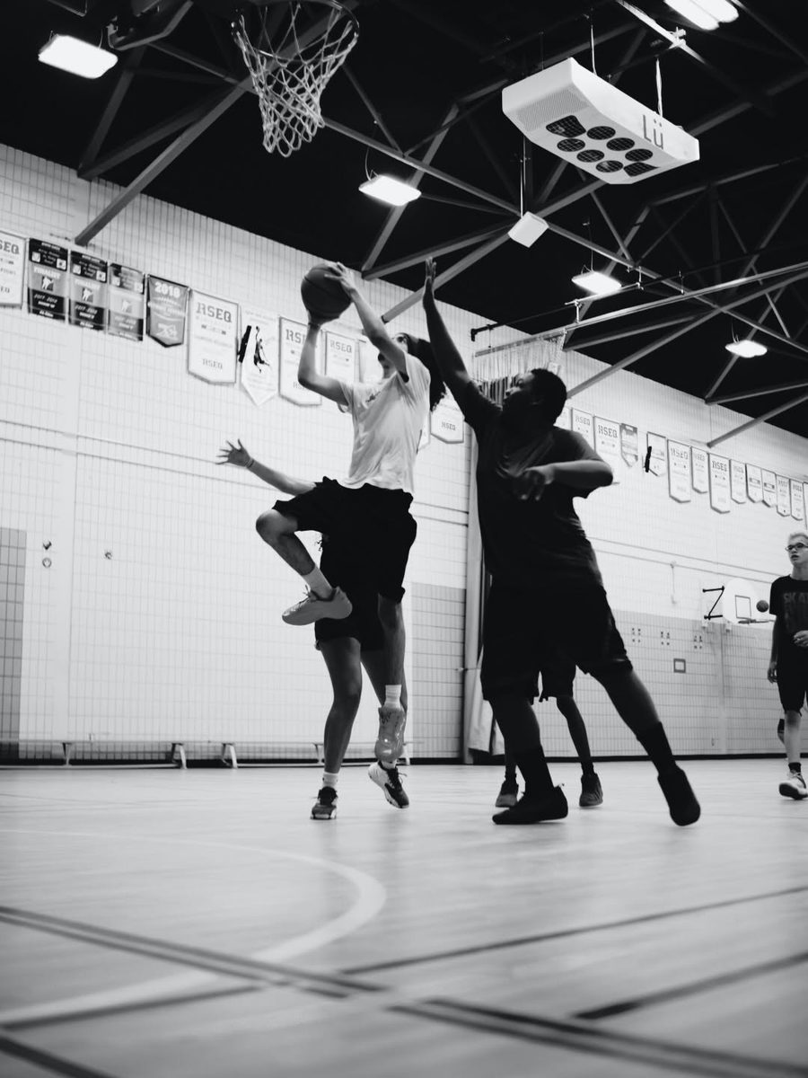 CHAMPS players contest a shot at the rim during practice
